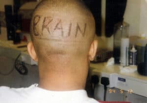 The word BRAIN shaved into the back of Bizzy B's head