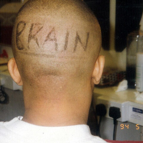 The word BRAIN shaved into the back of Bizzy B's head